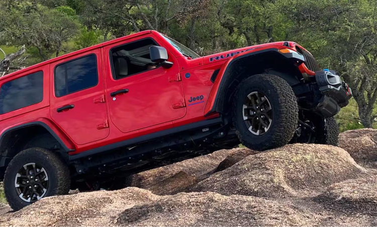 Jeep Wrangler driving up rocky terrain